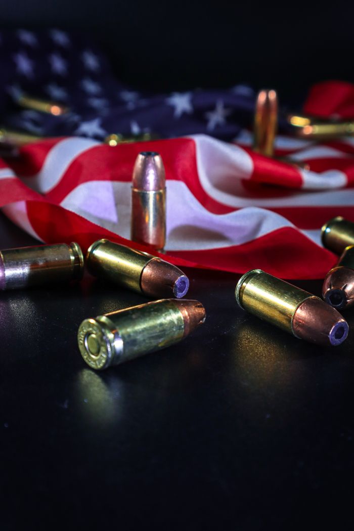 Crafting Captivating Headlines: Your awesome post title goes here Close-up of ammunition over an American flag, symbolizing patriotism and freedom.