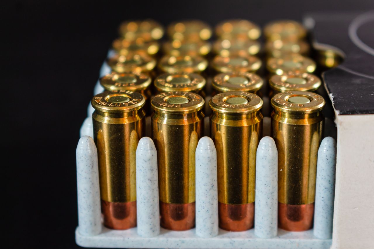 The Art of Drawing Readers In: Your attractive post title goes here Detailed view of ammunition bullets neatly arranged in a box, showcasing brass casings and copper tips.